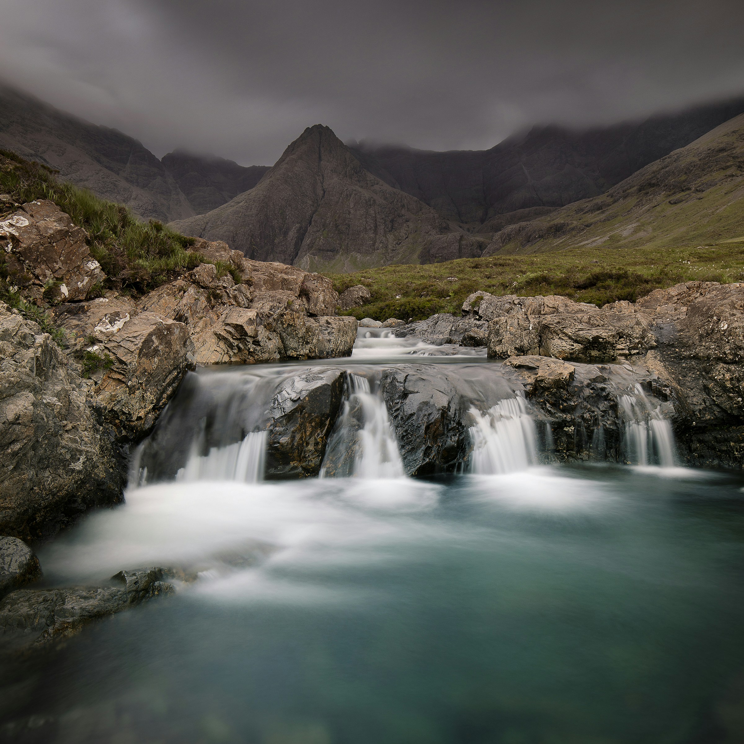 waterfalls surrounded by moutains